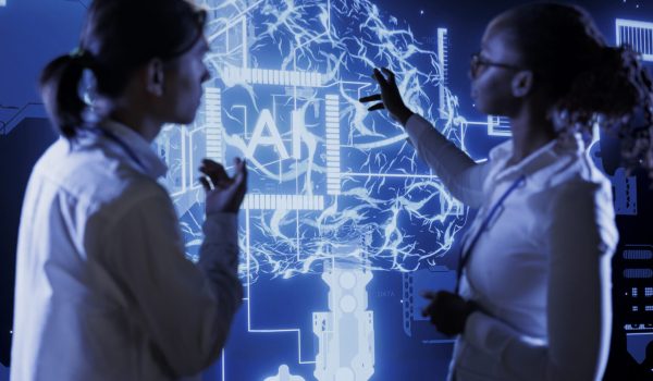 Qualified technicians brainstorm ways to use AI cognitive computing to extract usable information from complex data. Team of specialists implement artificial intelligence to process massive datasets